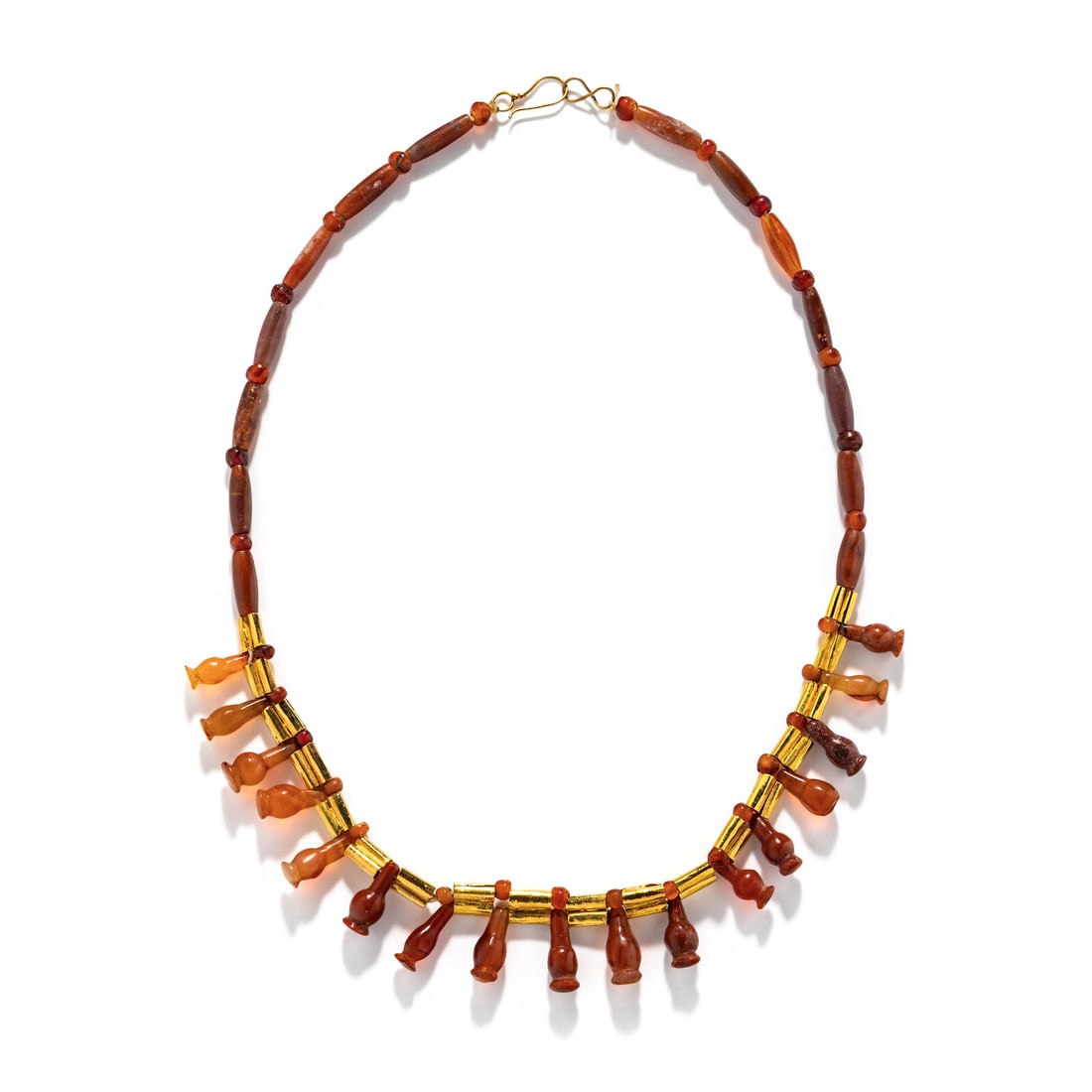 An Egyptian Gold and Carnelian Bead Necklace with Poppy Pendants: An Egyptian Gold and Carnelian Bead Necklace with Poppy Pendants New Kingdom, 18th-20th Dynasty, 1550-1070 B.C. Length 51 cm (20 1/8 inches); High karat gold; 36.69 grams. Property from a Private