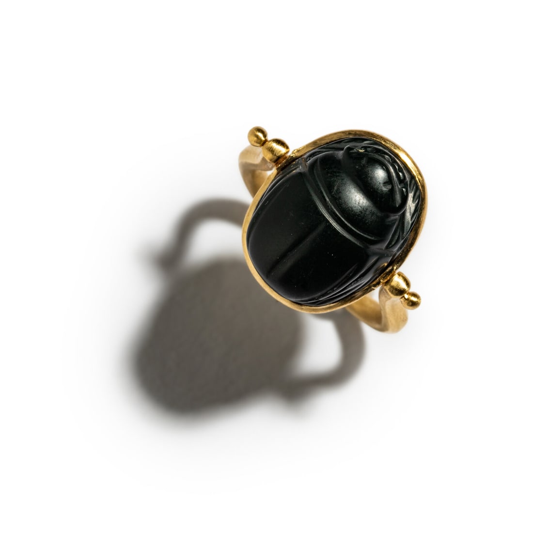 A Egypto-Phoenician Green Jasper Scarab with the God Bes: A Egypto-Phoenician Green Jasper Scarab with the God Bes Set in a gold swivel ring Circa 5th Century B.C. Height of ring 3.4 cm (1 3/8 inches); Ring size 11; 18 karat gold; 12.24 grams. Provenance: Le