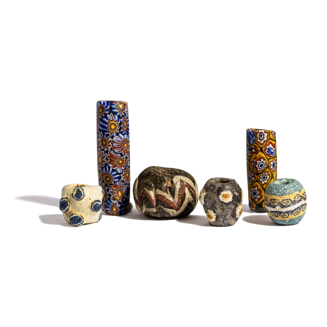 Four Phoenician and Two Venetian Millefiori Glass Beads: Four Phoenician and Two Venetian Millefiori Glass Beads Circa 6th-2nd Century B.C. and 19th-20th Century A.D. Length of largest 4.4 cm (1 3/4 inches). Provenance: Private Collection, Wisconsin, primar
