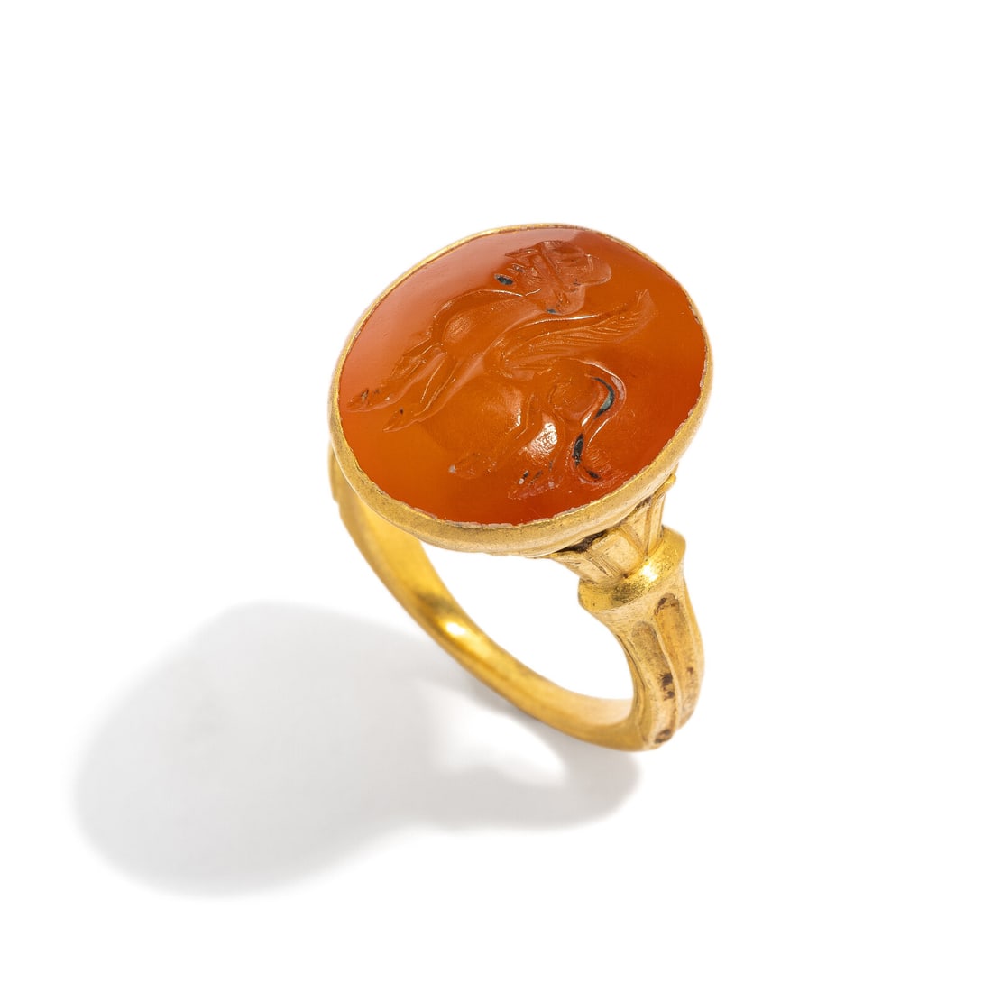 A Sasanian Carnelian Stamp Seal: A Sasanian Carnelian Stamp Seal Set in a 19th Century gold ring Circa 3rd-7th Century A.D. Height 3 cm (1 1/8 inches); Ring size 7 1/2; High karat gold; 12 grams. Provenance: Private Collection, New Y