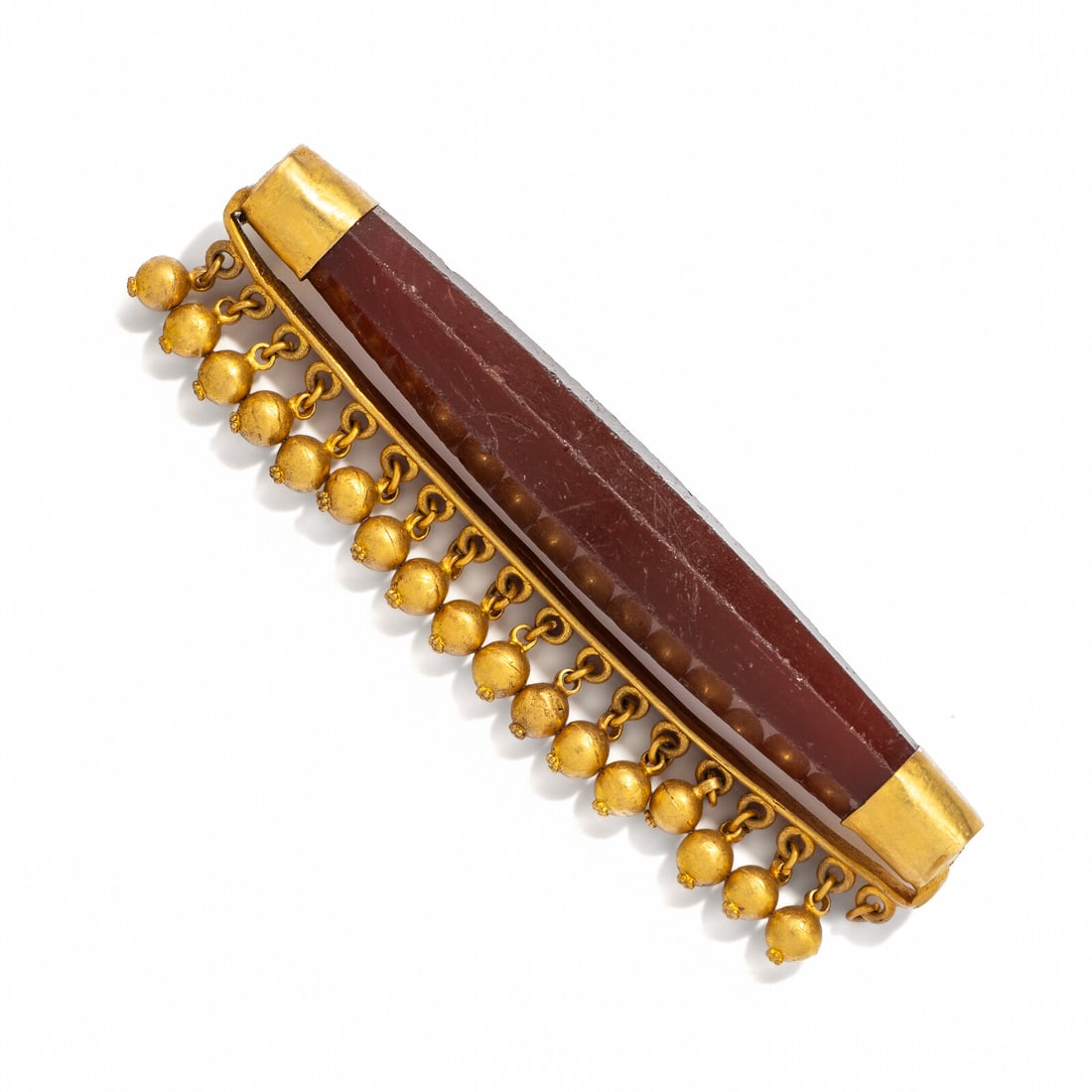 A Sasanian Carnelian and Gold Pendant: A Sasanian Carnelian and Gold Pendant Circa 3rd-7th Century A.D. Length 10.5 cm (4 1/8 inches); High karat gold; 64.29 grams. Provenance: Mehdi Mahboubian (1921-2005), New York and London. Patti