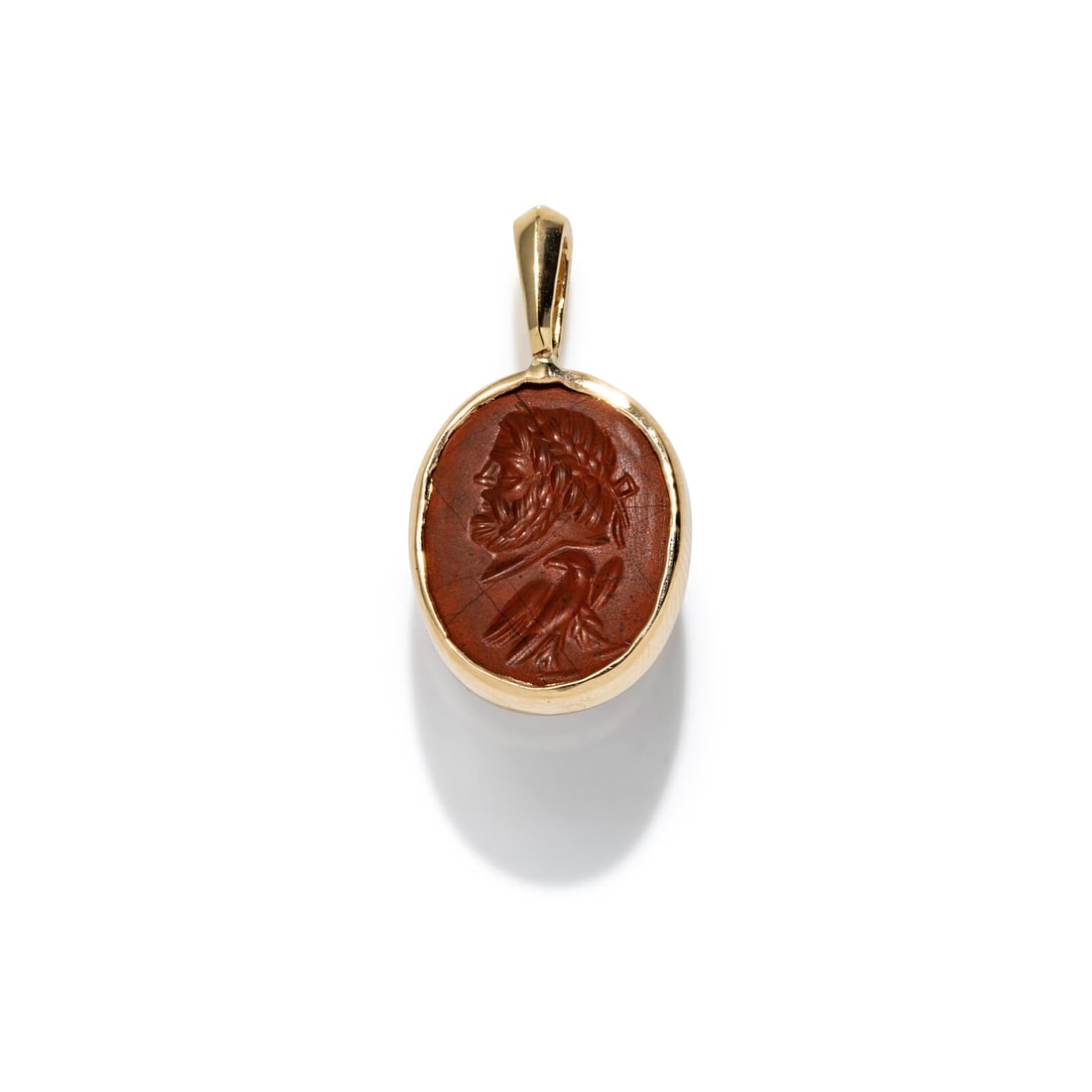 A Roman Red Jasper Ring Stone with the God Jupiter: A Roman Red Jasper Ring Stone with the God Jupiter Set in a gold pendant Circa 1st-2nd Century A.D. Height of pendant 2.2 cm (7/8 inch); 14 karat gold; 1.43 grams. Provenance: Lee Kieffer Collection,