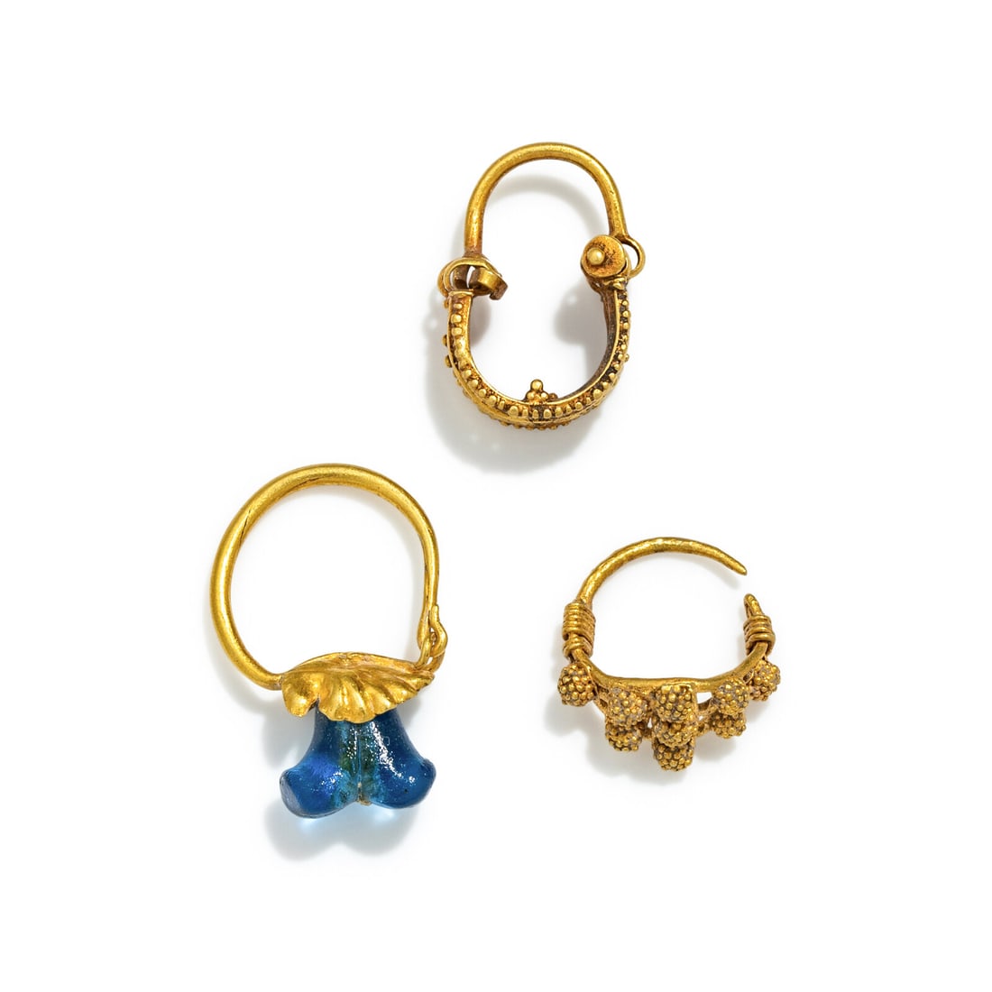 Three Roman Gold and Glass Earrings: Three Roman Gold and Glass Earrings Circa 1st-2nd Century A.D. Height of tallest 2.1 cm (7/8 inch); High karat gold; 4.74 grams. Provenance: Private Collection, New York, 2000s.