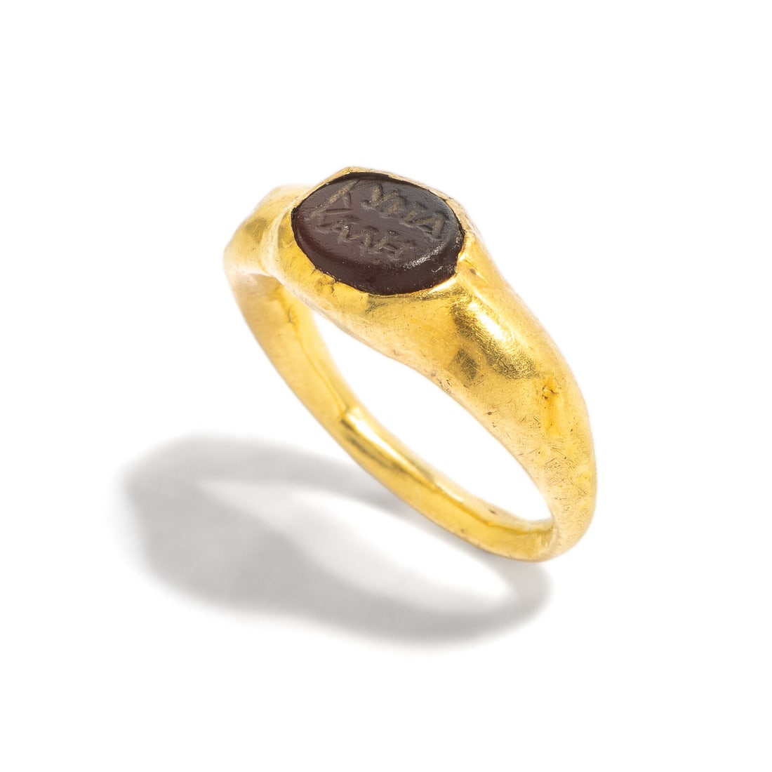 A Late Roman or Byzantine Gold and Carnelian Finger Ring: A Late Roman or Byzantine Gold and Carnelian Finger Ring Circa 3rd-4th Century A.D. Width 1.7 cm (5/8 inch); Ring size 1; High karat gold; 2.26 grams. Property from Mari Anne Christie, Aurora, Colorad
