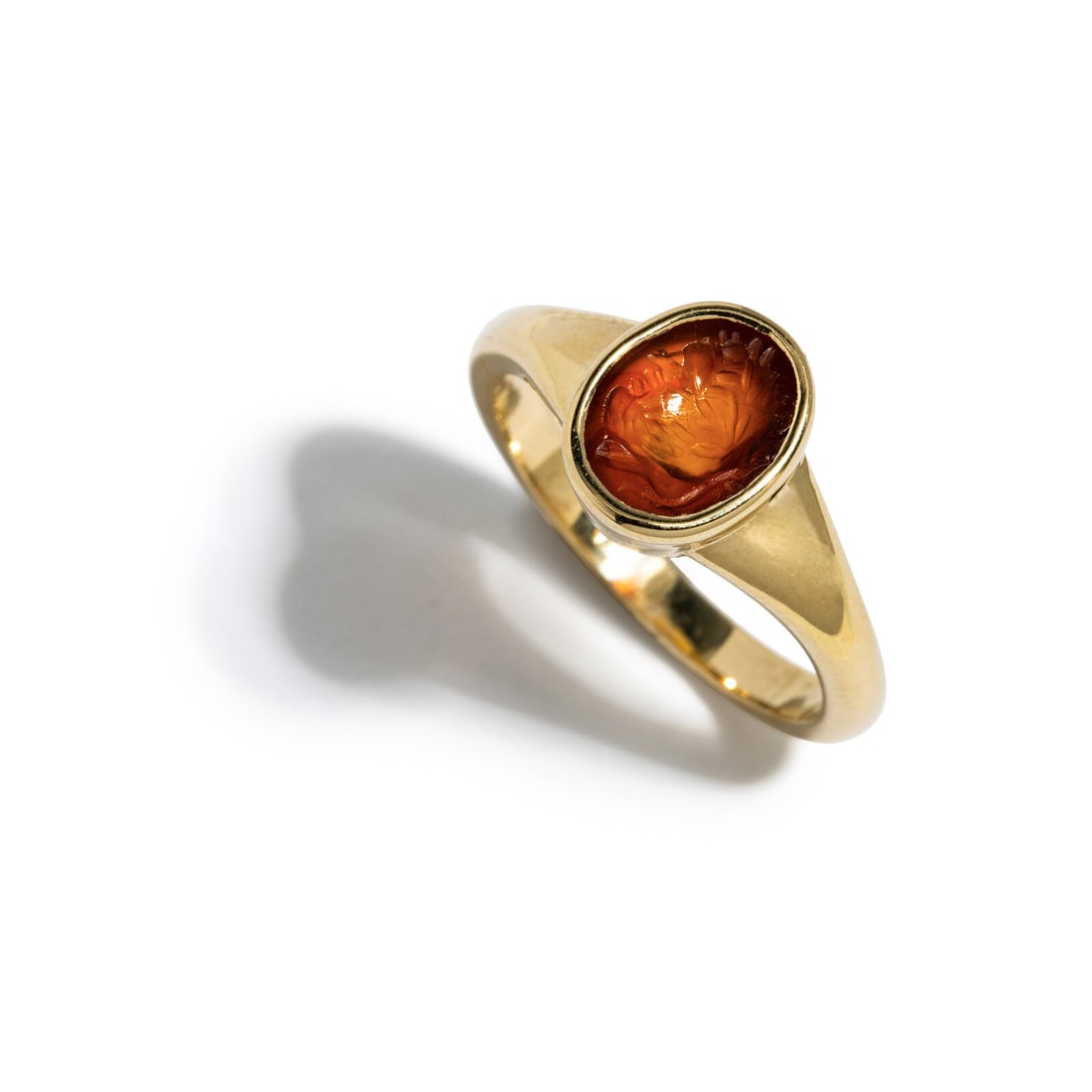 A Roman Carnelian Ring Stone with a Male Portrait Head: A Roman Carnelian Ring Stone with a Male Portrait Head Circa 1st-2nd Century A.D. Height 2.4 cm (1 inch); Ring size 6 3/4; 14 karat gold; 4.77 grams. Provenance: Lee Kieffer Collection, Loudon,
