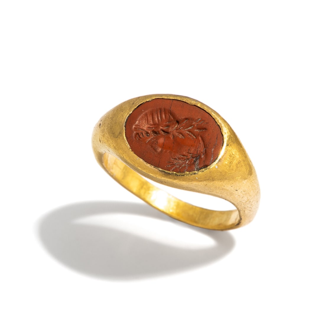 A Roman Gold and Red Jasper Finger Ring with a Male God: A Roman Gold and Red Jasper Finger Ring with a Male God Circa 1st-2nd Century A.D. Height 2.4 cm (1 inch); Ring size 9; High karat gold; 9.46 grams. Provenance: Private Collection, Bergen County, New
