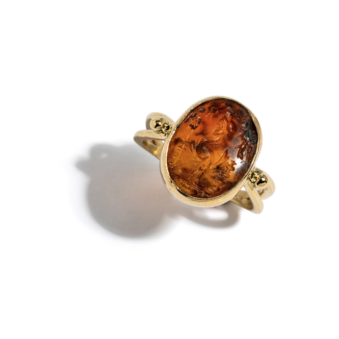 A Roman Carnelian Ring Stone with the God Serapis and an Eagle: A Roman Carnelian Ring Stone with the God Serapis and an Eagle Set in a gold ring Circa 2nd Century A.D. Width 2.2 cm (7/8 inch); Ring size 7 3/4; 14 karat gold; 4.31 grams. Provenance: Lee Kieffer