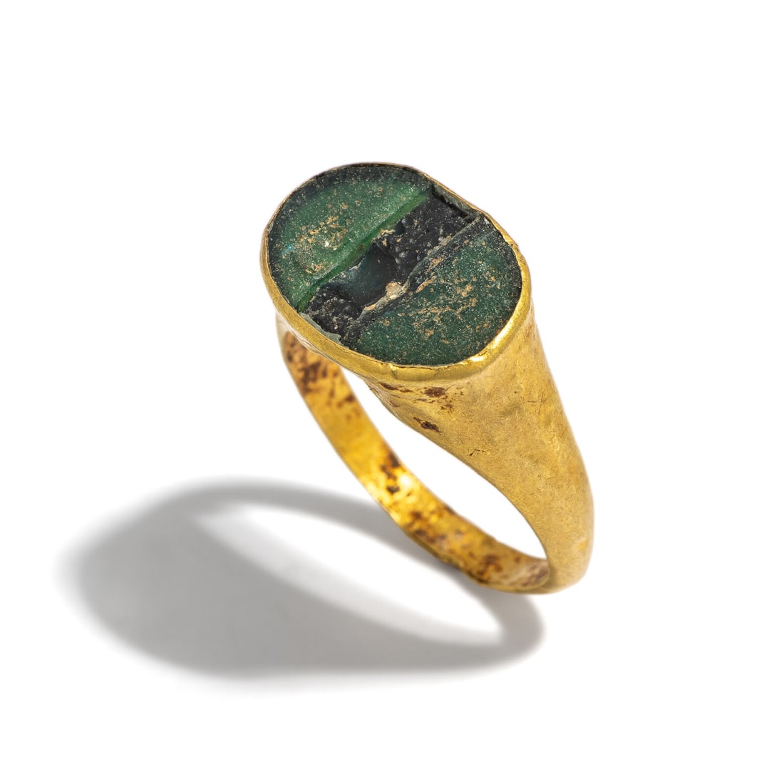A Roman Gold and Glass Finger Ring: A Roman Gold and Glass Finger Ring Circa 1st-2nd Century A.D. Height 2.3 cm (7/8 inch); Ring size 5 1/2; High karat gold; 2.06 grams. Provenance: Private Collection, Bergen County, New Jersey, formed