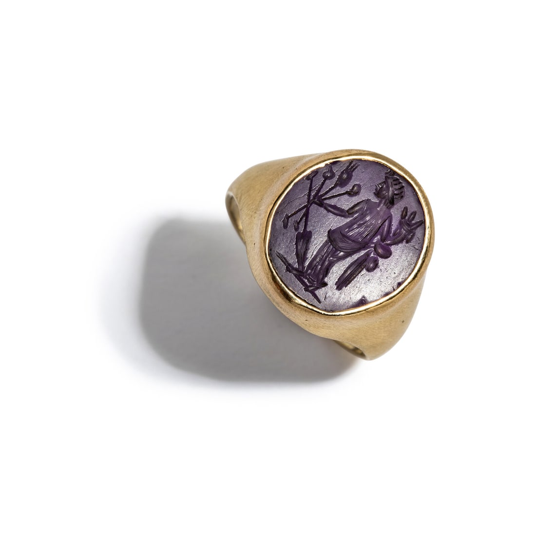 A Roman Amethyst Ring Stone with the Goddess Tyche: A Roman Amethyst Ring Stone with the Goddess Tyche Set in a gold ring Circa 2nd Century A.D. Height 2.3 cm (7/8 inch); 14 karat gold; Ring size 7 3/4; 5.22 grams. Provenance: Lee Kieffer Collection,