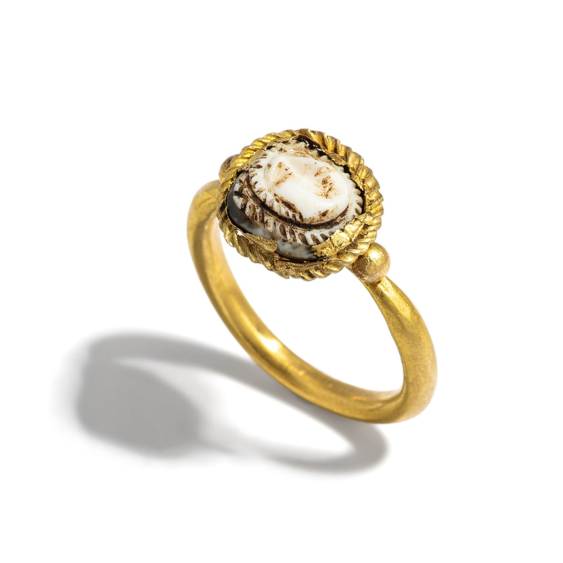 A Roman Gold and Onyx Cameo Finger Ring with the Head of Medusa: A Roman Gold and Onyx Cameo Finger Ring with the Head of Medusa Circa 1st-3rd Century A.D. Height 2.4 cm (1 inch); Ring size 6 1/4; High karat gold; 4.35 grams. Provenance: Private Collection,