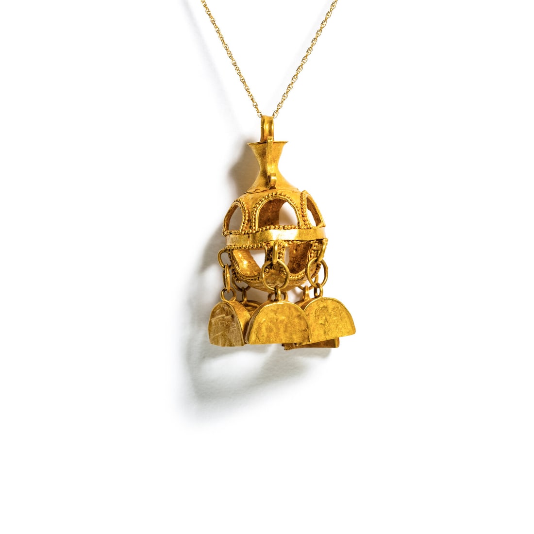 A Parthian Gold Earring with Crescent-Shape Bells: A Parthian Gold Earring with Crescent-Shape Bells with a modern gold chain Circa 3rd-2nd Century B.C. Height 4.2 cm (1 5/8 inches); High karat gold; 6.67 grams. Provenance: Private Collection, New Yor