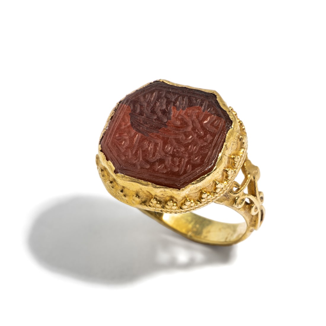 A Safavid Gold and Carnelian Seal Ring: A Safavid Gold and Carnelian Seal Ring Circa 18th Century A.D. Height 2.4 cm (1 inch); Ring size 6 3/4; 18 karat gold; 7.35 grams. Provenance: Private Collection, Bergen County, New Jersey, formed