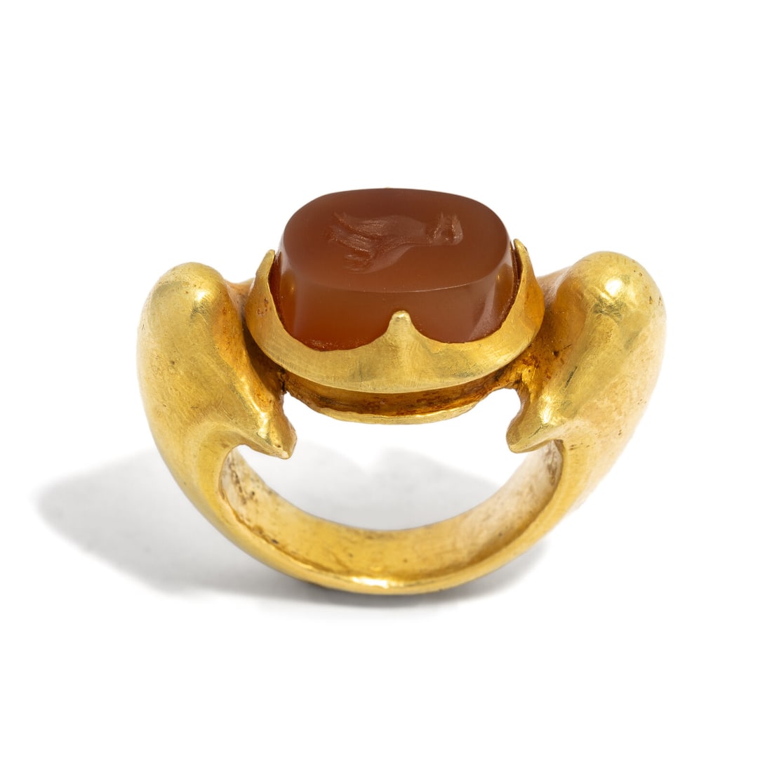 A Central Javanese Gold and Carnelian Ring with Garuda: A Central Javanese Gold and Carnelian Ring with Garuda Circa 9th-10th Century A.D. Width 3 cm (1 1/8 inches); Ring size 5; High karat gold; 28 grams. Property from a Florida Private Collection 
