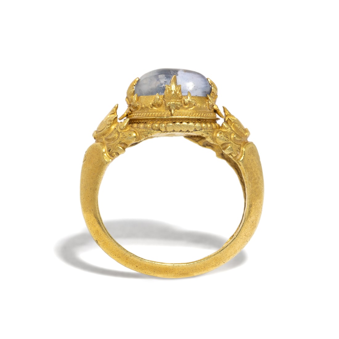 A Central Javanese Gold and Tumbled Sapphire Ring: A Central Javanese Gold and Tumbled Sapphire Ring Circa 9th-11th Century A.D. Height 2.7 cm (1 1/8 inch); Ring size 6 1/2; High karat gold; 6 grams. Property from a Florida Private Collection 