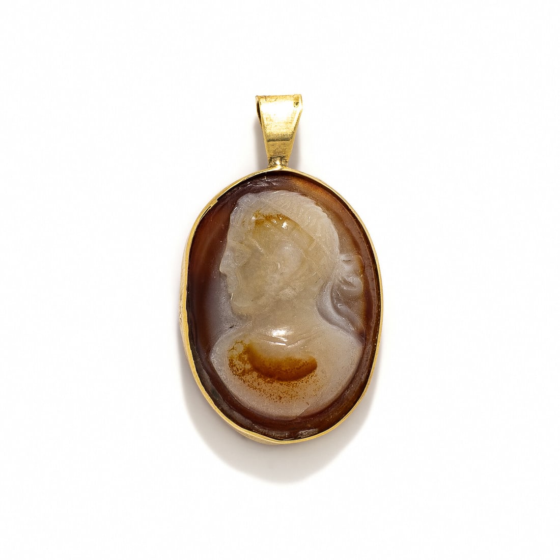 A Neoclassical Sardonyx Cameo with the Portrait Head of a Roman Emperor: A Neoclassical Sardonyx Cameo with the Portrait Head of a Roman Emperor Height of pendant 3.6 cm (1 3/8 inches); High karat gold; 8.05 grams.