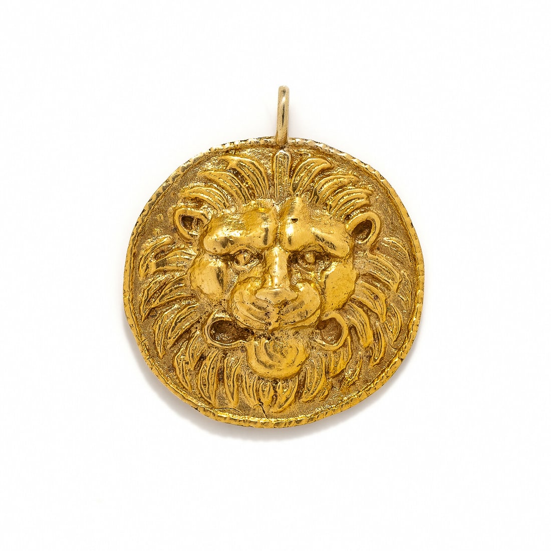 A Roman Style Lion-Headed Pendant: A Roman Style Lion-Headed Pendant After the Antique Height 3.4 cm (1 3/8 inches); High karat gold; 10 grams.