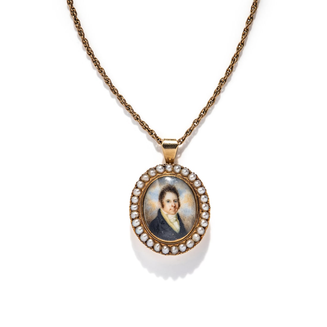 VICTORIAN, YELLOW GOLD AND SEED PEARL MOURNING PENDANT: VICTORIAN, YELLOW GOLD AND SEED PEARL MOURNING PENDANT Miniature portrait and seed pearls, with a hair element on the reverse. Mounted in yellow gold, with a later gold-filled chain. Pendant: 1 1/2