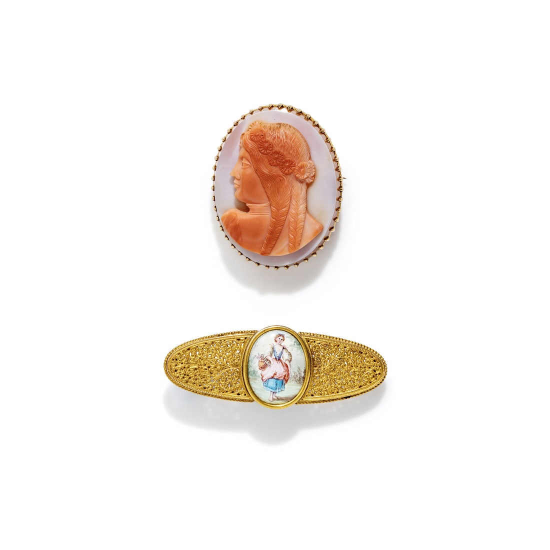 TWO YELLOW GOLD FIGURAL BROOCHES: TWO YELLOW GOLD FIGURAL BROOCHES Including two brooches, one set with a carnelian cameo measuring approximately 39.50 x 31.30 mm and the other set with painted porcelain. Yellow gold and 14 karat