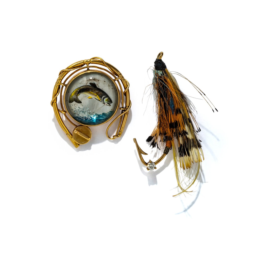 COLLECTION OF YELLOW GOLD FISHING MOTIF BROOCHES: COLLECTION OF YELLOW GOLD FISHING MOTIF BROOCHES Including two brooches, the first set with Essex crystal measuring approximately 19.00 mm depicting a trout and the other set with a fishing lure and a