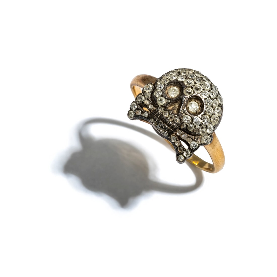 RUSSIAN, DIAMOND, SILVER, AND YELLOW GOLD SKULL AND CROSSBONES RING: RUSSIAN, DIAMOND, SILVER, AND YELLOW GOLD SKULL AND CROSSBONES RING Old European cut diamonds weighing approximately 0.40 carat total and rose cut diamonds. Silver and 14 karat yellow gold. Ring size