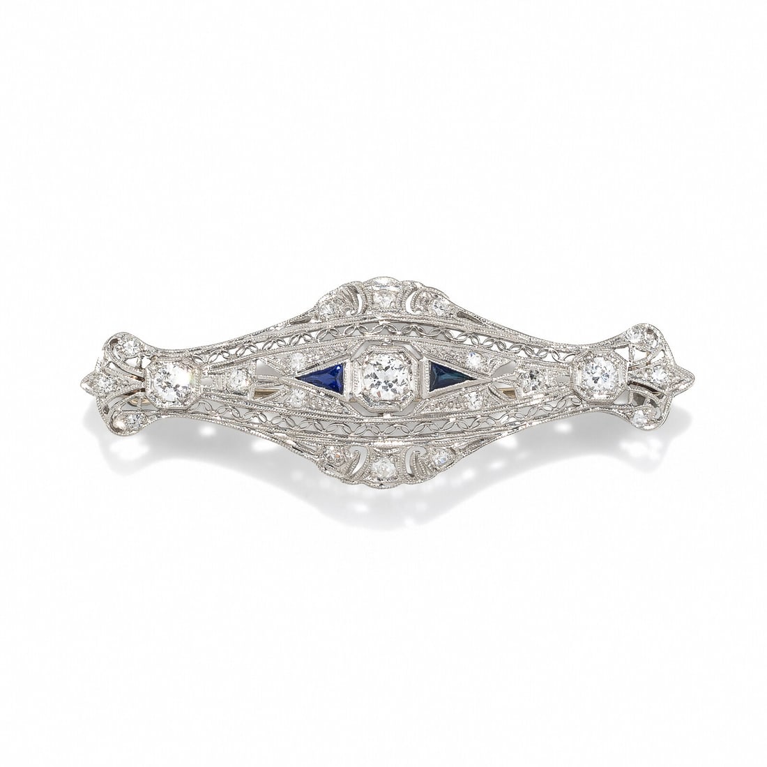 DIAMOND AND SYNTHETIC SAPPHIRE BROOCH: DIAMOND AND SYNTHETIC SAPPHIRE BROOCH Calibré-cut synthetic sapphires, and old European, transitional, and single cut diamonds weighing approximately 0.85 carat total. Platinum. 2 3/16 inches