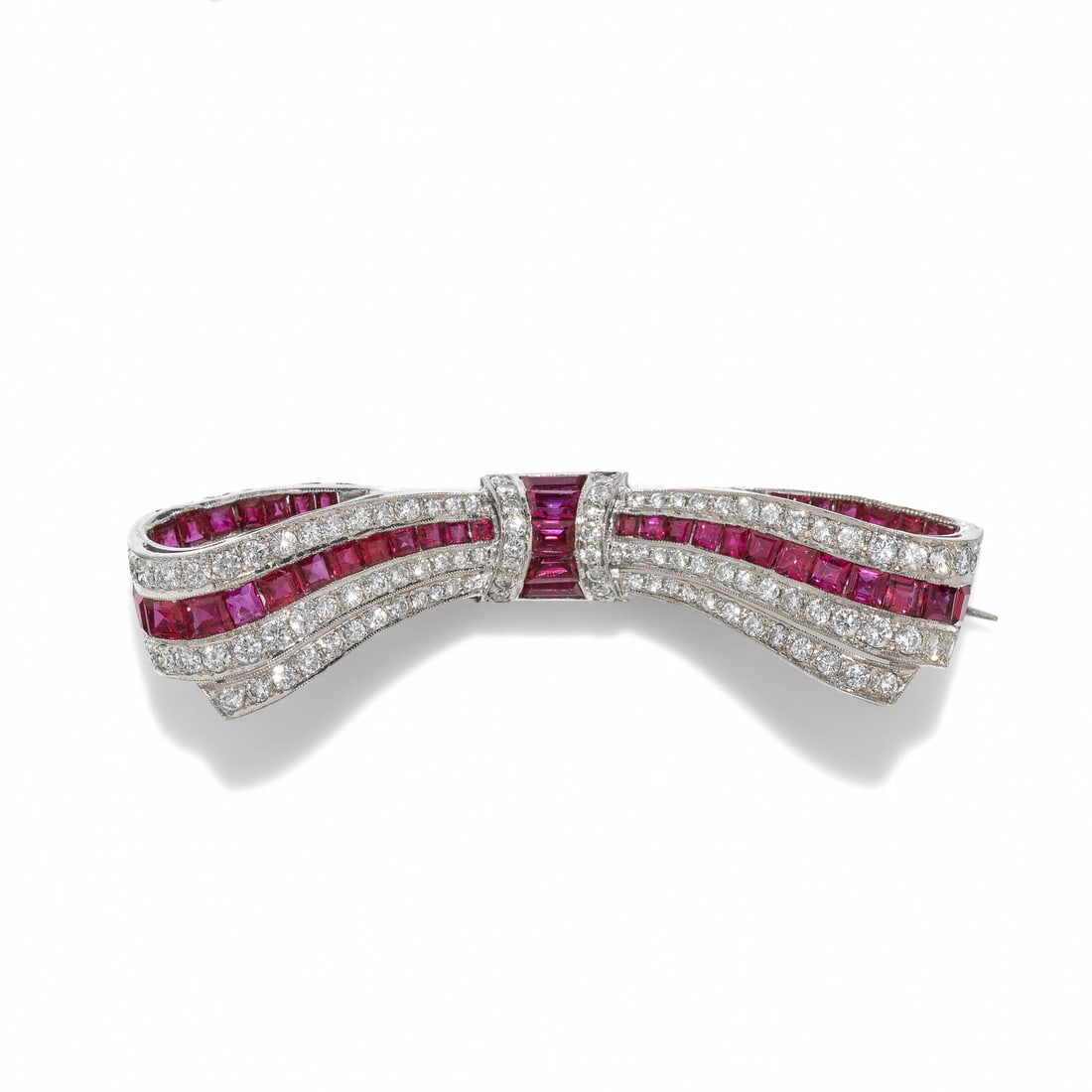 RUBY AND DIAMOND BOW BROOCH: RUBY AND DIAMOND BOW BROOCH Round diamonds weighing approximately 1.20 carats and calibré-cut rubies. 18 karat white gold. 2 1/4 inches long. Stamp: 750 13662 2. Gross weight: 6.35 dwt. Property