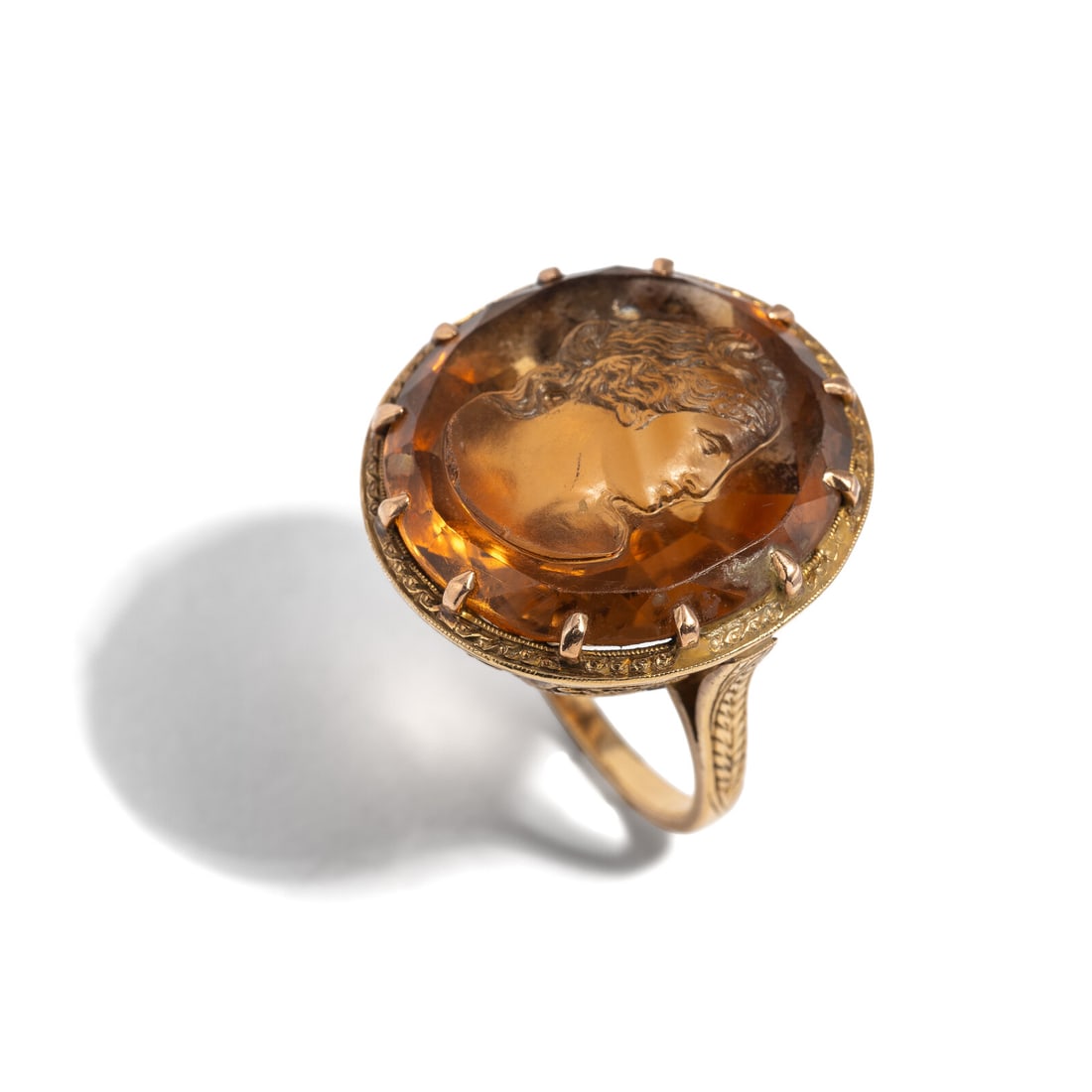 CITRINE CAMEO AND DIAMOND RING: CITRINE CAMEO AND DIAMOND RING Round citrine cameo measuring approximately 22.85 x 21.80 mm and single cut diamonds. Yellow gold. Ring size 7 1/4. Gross weight: 8.85 dwt. Property of a Prominent
