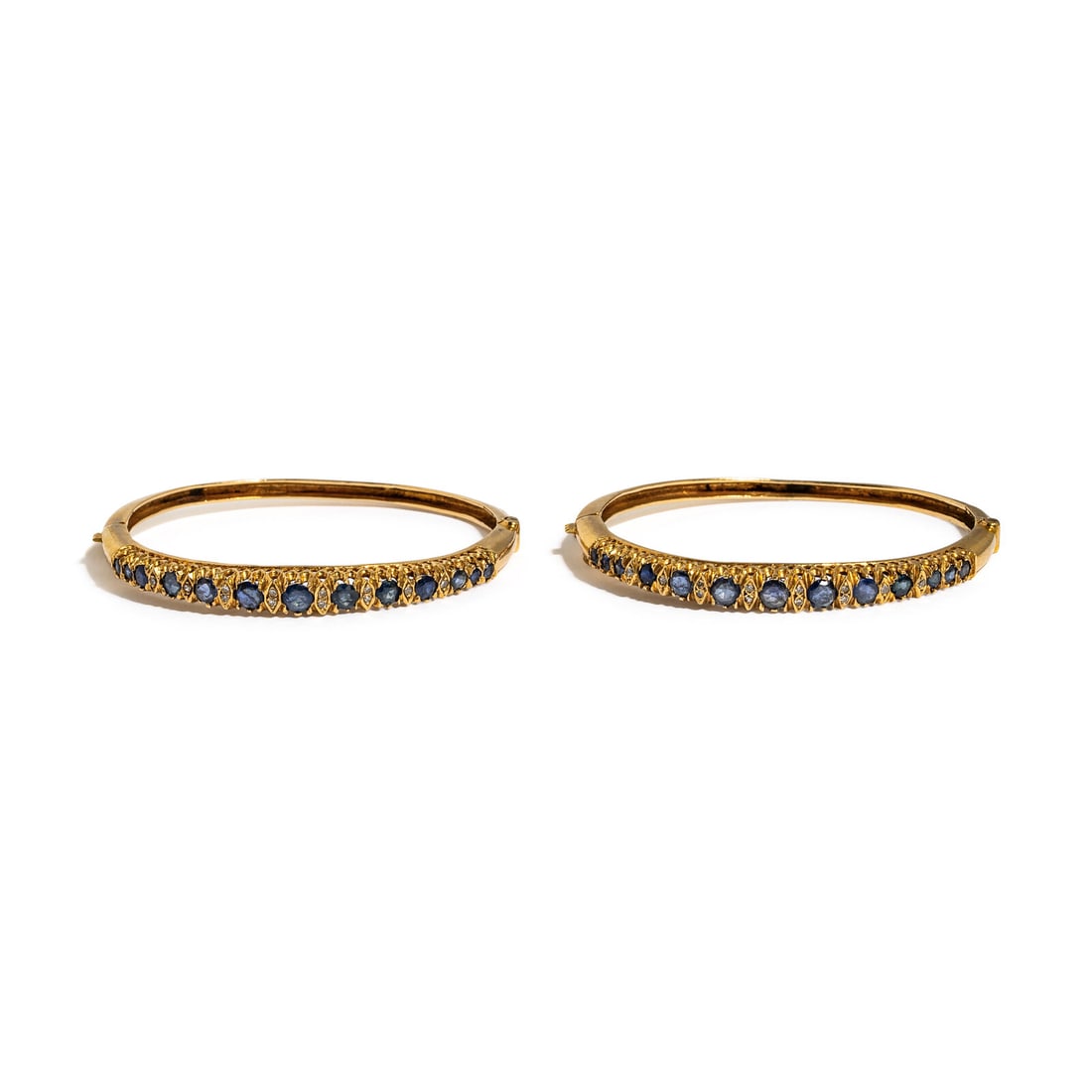 PAIR OF YELLOW GOLD, SAPPHIRE, AND DIAMOND BANGLE BRACELETS: PAIR OF YELLOW GOLD, SAPPHIRE, AND DIAMOND BANGLE BRACELETS Round sapphires and single cut diamonds. 14 karat yellow gold. 6 inches inner circumference. Stamp: 14K. Gross weight: 18.50 dwt. Property