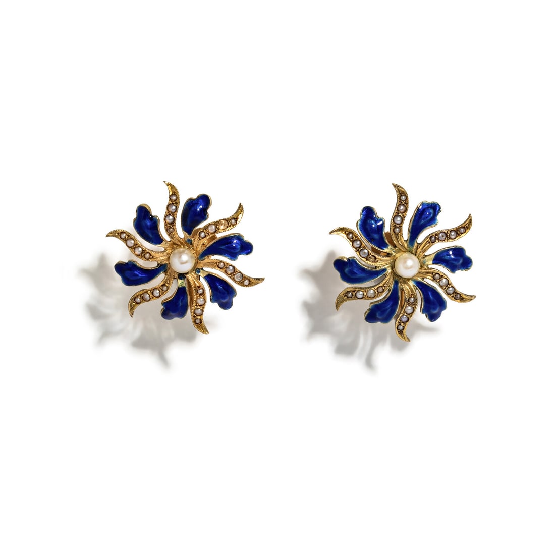 YELLOW GOLD, ENAMEL, AND SEED PEARL FLOWER EARRINGS: YELLOW GOLD, ENAMEL, AND SEED PEARL FLOWER EARRINGS Blue enamel and seed pearls, centered by two slightly larger pearls. 14 karat yellow gold. 1 inch wide. Stamp: 14K Gross weight: 4.10 dwt. This lot