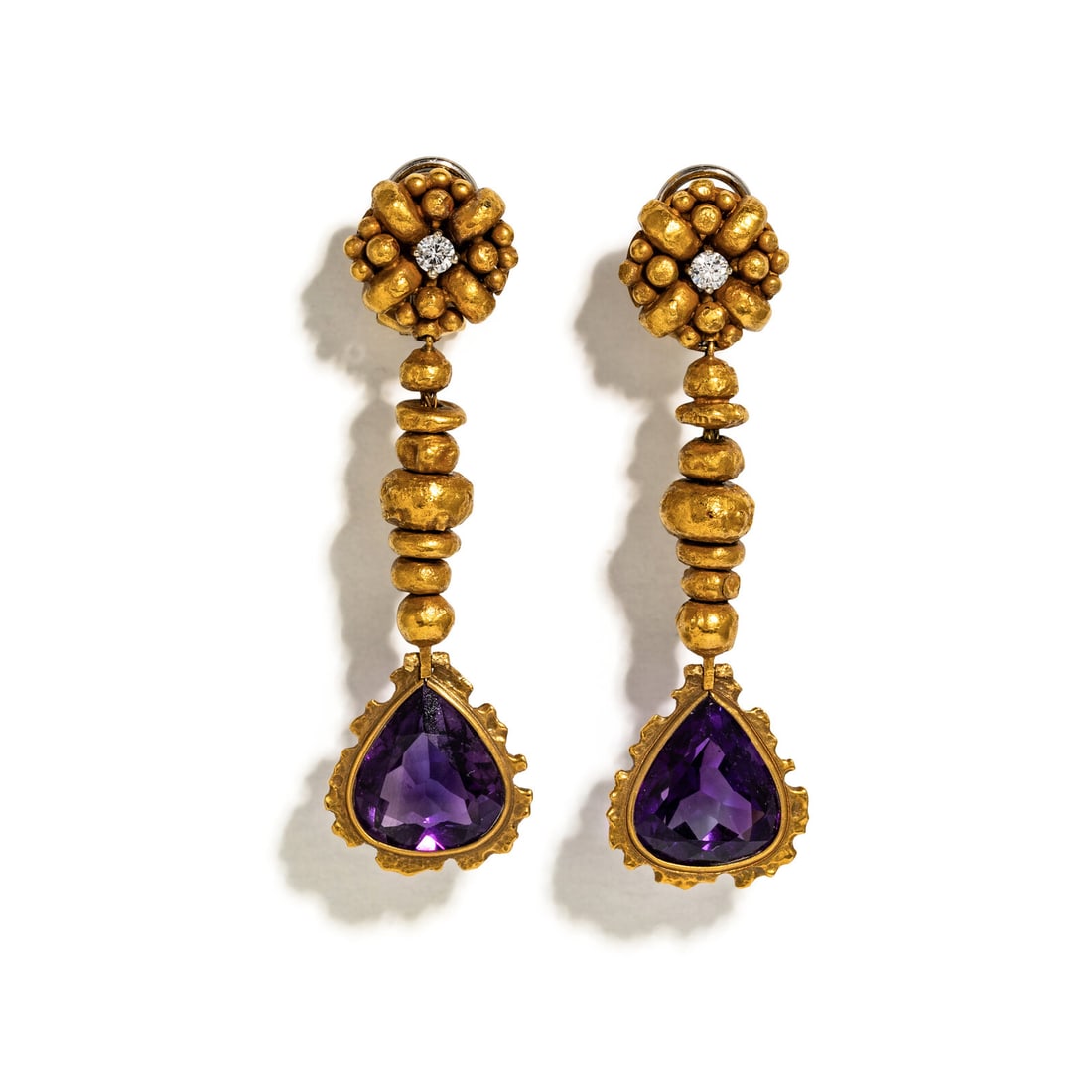AMETHYST, DIAMOND, AND YELLOW GOLD PENDANT DROP EARRINGS: AMETHYST, DIAMOND, AND YELLOW GOLD PENDANT DROP EARRINGS Pear shape amethysts measuring approximately 13.35 x 12.38 x 7.20 mm and round diamonds weighing approximately 0.21 carats total. 18 karat