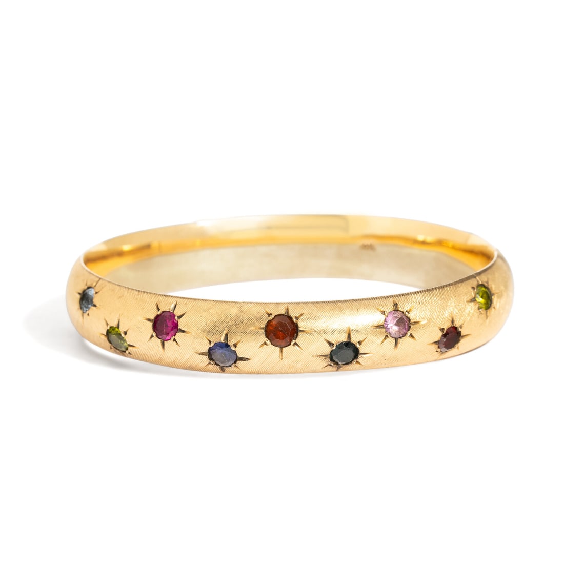 YELLOW GOLD AND COLORED STONE BANGLE BRACELET: YELLOW GOLD AND COLORED STONE BANGLE BRACELET Set with round colored stones, hinged with side clasp. 14 karat yellow gold. 6 5/8 inches inner circumference. Stamp: 14K. Gross weight: 13.85 dwt.