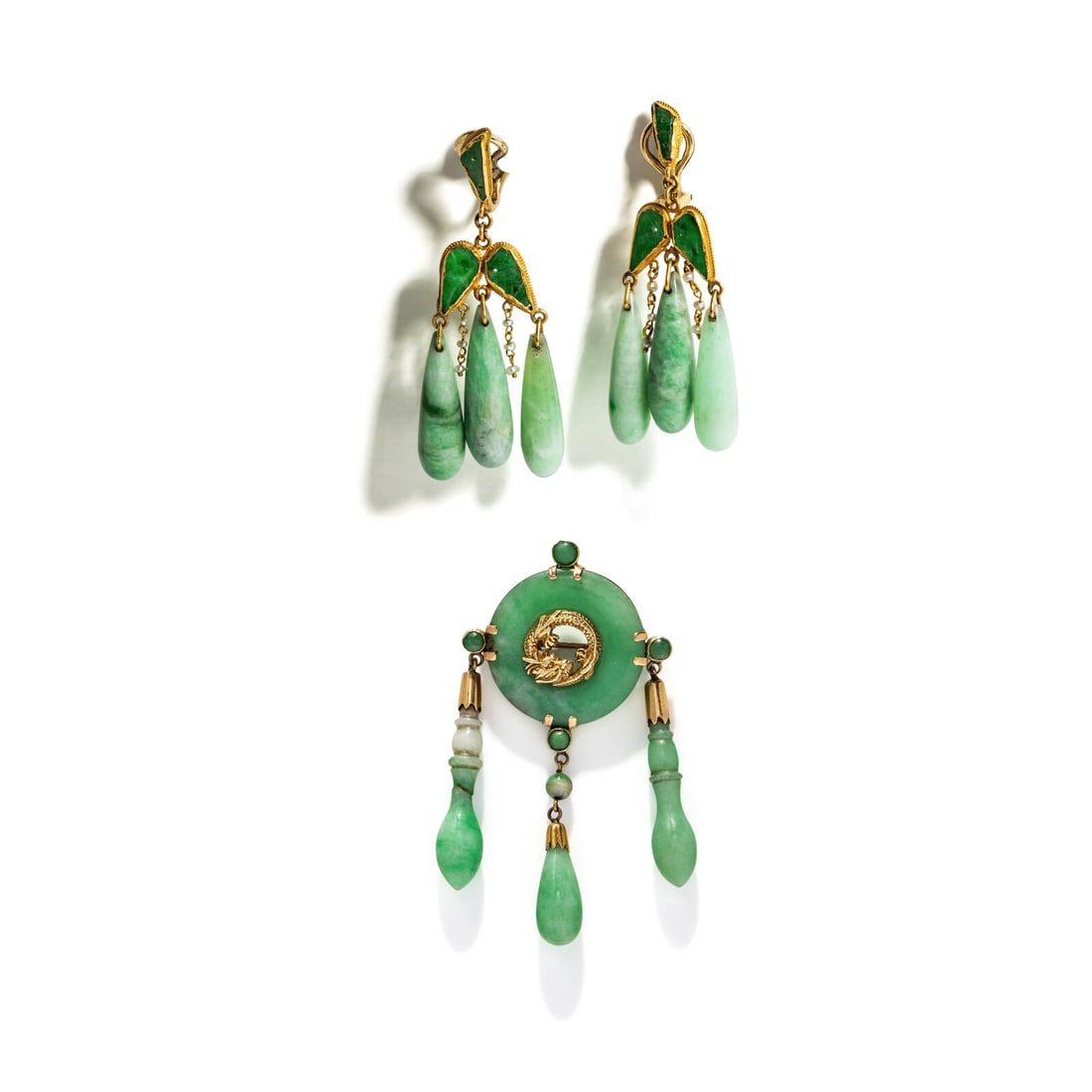 JADE AND YELLOW GOLD BROOCH AND EARRINGS: JADE AND YELLOW GOLD BROOCH AND EARRINGS Including a brooch set with a jade disc, round carved jade, and carved jade drops, and a pair of earrings set with carved and pierced jade, jade drops, and