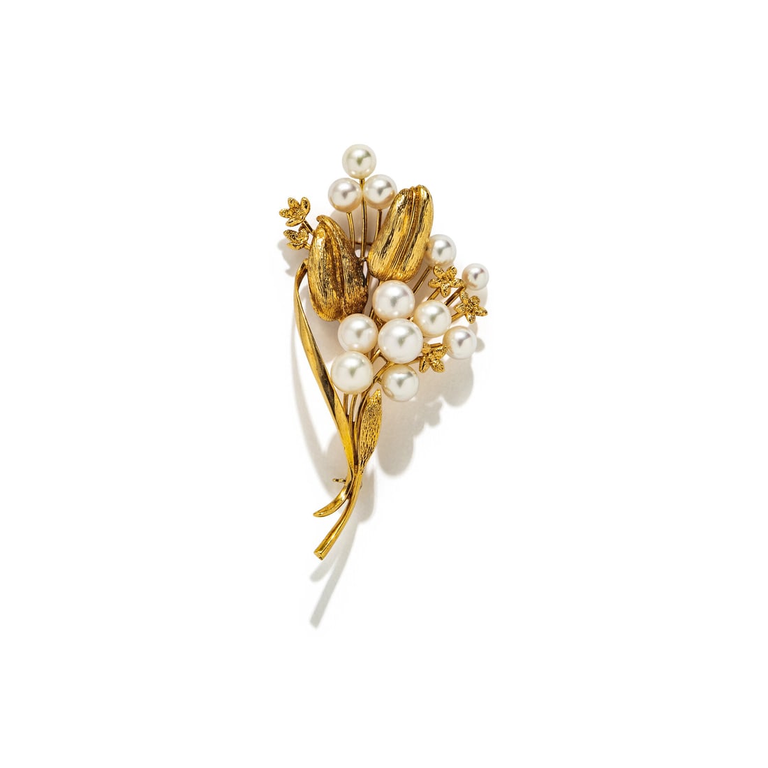 MIKIMOTO, CULTURED PEARL AND YELLOW GOLD FLOWER BROOCH: MIKIMOTO, CULTURED PEARL AND YELLOW GOLD FLOWER BROOCH Cultured pearls measuring approximately 5.10 - 8.30 mm. 14 karat yellow gold. 3 x 1 1/2 inches. Stamp: (Mikimoto maker's mark) K14. Gross