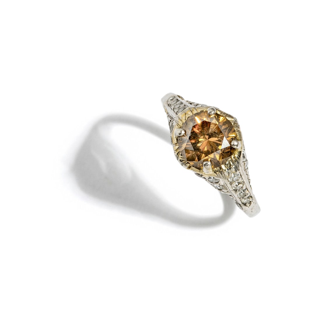 BROWN DIAMOND AND DIAMOND RING: BROWN DIAMOND AND DIAMOND RING Round brown diamond (origin of color not tested) weighing approximately 0.90 carat, and single cut diamonds. 18 karat white gold. Ring size 2 3/4. Stamp: 18 (partially