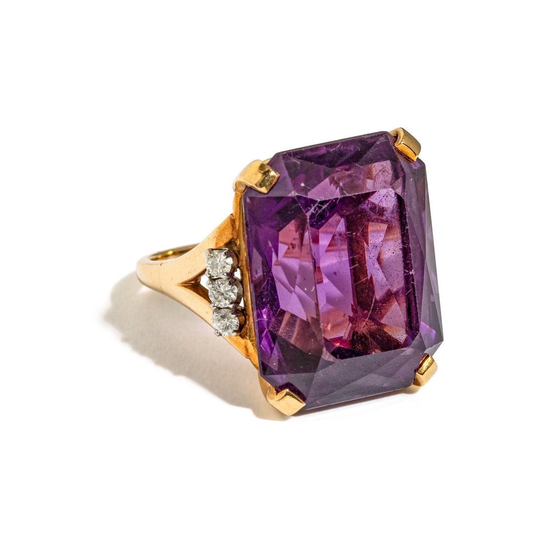 AMETHYST, DIAMOND, AND YELLOW GOLD RING: AMETHYST, DIAMOND, AND YELLOW GOLD RING Emerald cut amethyst weighing approximately 38.00 carats by formula and round diamonds. 14 karat yellow gold. Ring size 7. Stamp: 14K. Gross weight: 10.55 dwt.