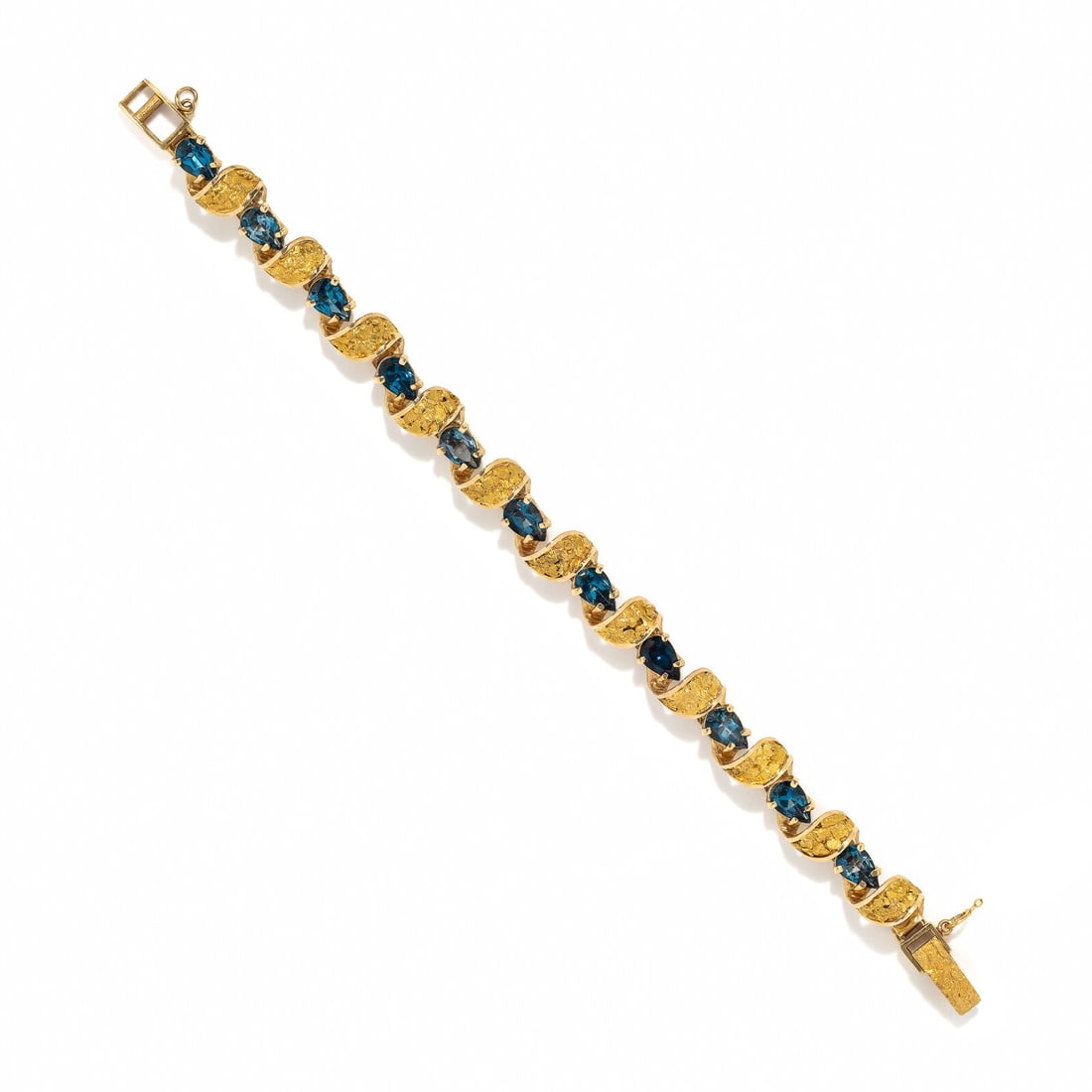YELLOW GOLD AND BLUE TOPAZ BRACELET: YELLOW GOLD AND BLUE TOPAZ BRACELET Pear shape blue topaz. 14 karat yellow gold. 6 3/4 inches long. Stamp: 14K (maker's mark). Gross weight: 16.20 dwt. Property from a Private Collection, Atlanta, Geo