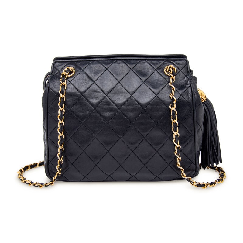 Chanel, Black Square Shoulder Bag: Chanel, Black Square Shoulder Bag Square shoulder bag in quilted black lambskin leather with gold-tone hardware. Zipper closure with leather tassel pull and interwoven leather-metal chain straps. 