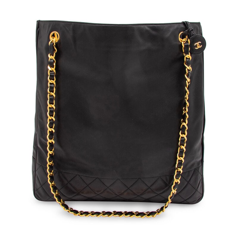 Chanel, Large Black Leather Tote: Chanel, Large Black Leather Tote Large shoulder tote bag in black lambskin leather with quilted elements and gold-tone hardware. Snap closures and interwoven leather-metal chain straps. Label: