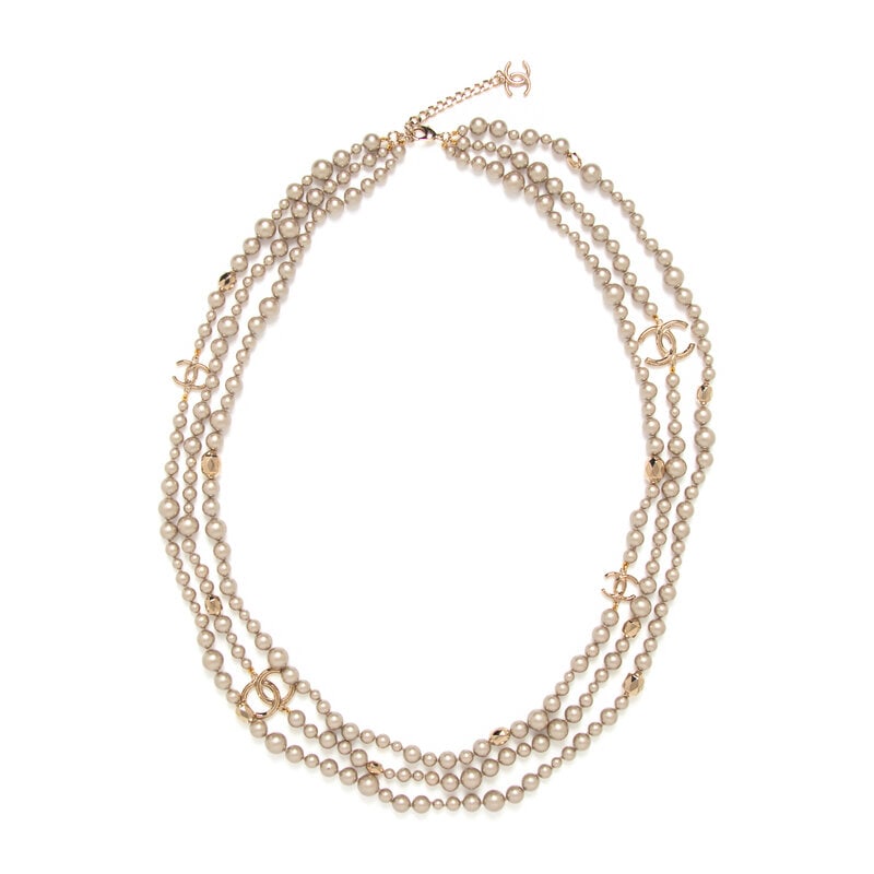 Chanel, Triple-Layered Gripoix Pearl Sautoir: Chanel, Triple-Layered Gripoix Pearl Sautoir Layered-triple stand sautoi with taupe-colored Gripoix pearl beads, pale gold-tone metal beads and CC charms. Lobster clasp closure. Label: Chanel