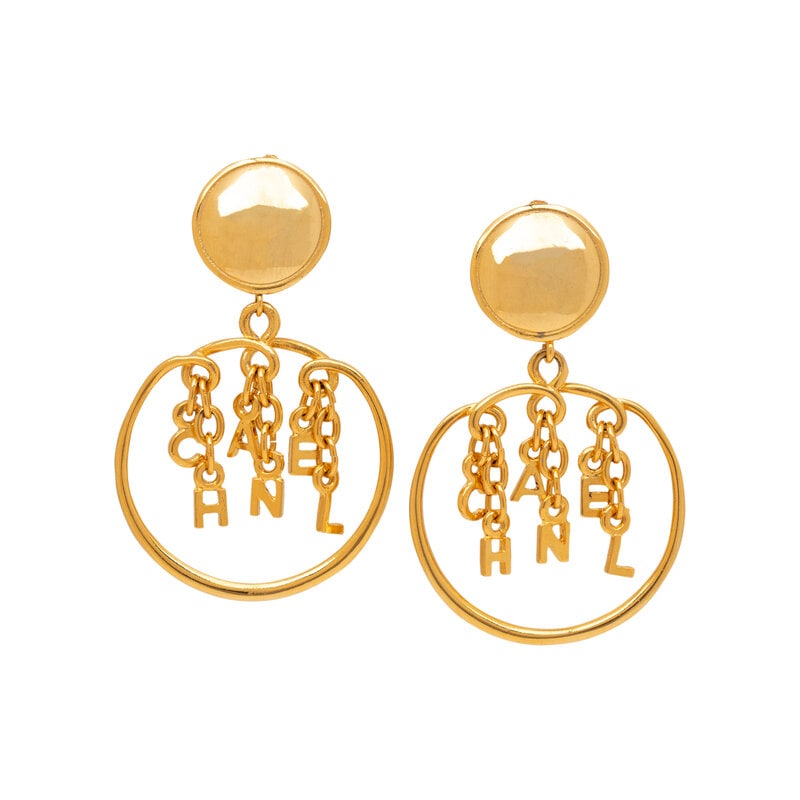 Chanel, Dangling Letter Charm Ear Clips: Chanel, Dangling Letter Charm Ear Clips Pair of dangling hoop & "CHANEL" letter charm ear clips in gold-tone metal. Standard ear clip backs. Stamped with maker's marks at back. Label: Chanel