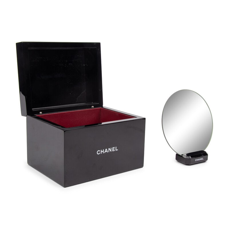 Chanel, Lacquered Logo Box & Vanity Mirror: Chanel, Lacquered Logo Box & Vanity Mirror Vanity/jewelry box & vanity mirror in black-lacquered composite. Includes two boxes. Label: Chanel Date: Late 20th - Early 21st Century 