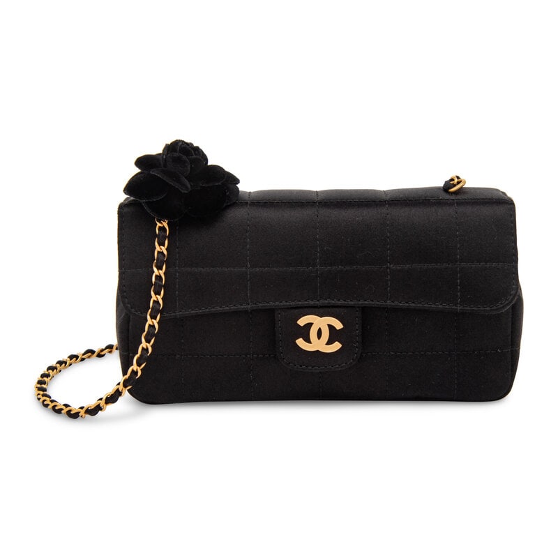 Chanel, Mini Satin Flap Bag with Camellia: Chanel, Mini Satin Flap Bag with Camellia Mini flap bag in black satin with square topstitching and brushed gold-tone hardware. Black velvet camellia attached to top. Magnetic snap closure and