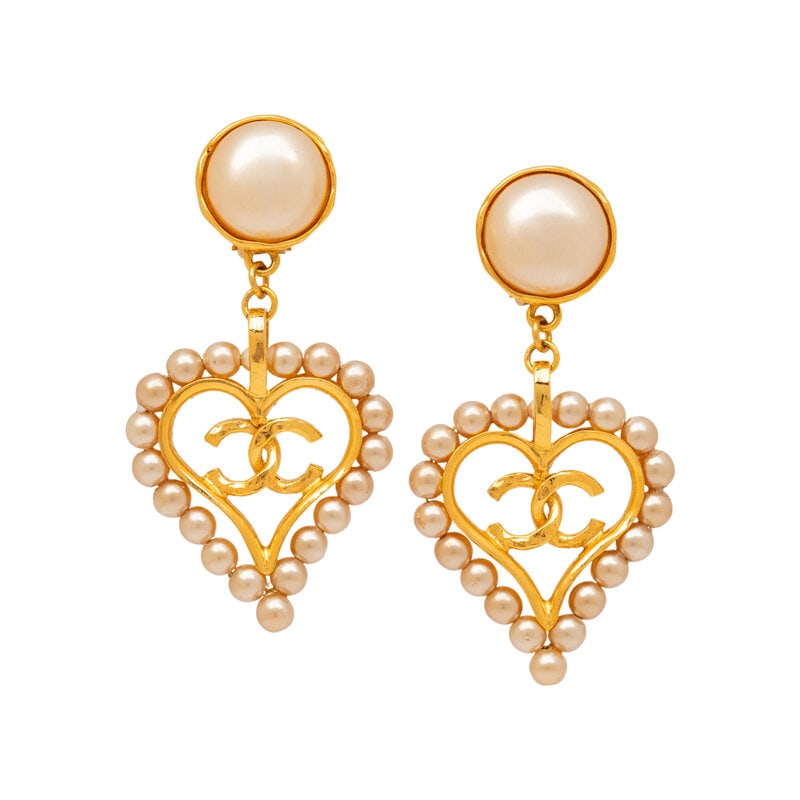 Chanel, Heart-Shaped CC Ear Clips: Chanel, Heart-Shaped CC Ear Clips Pair of ear clips in gold-tone metal with Gripoix pearl settings and dangling heart-shaped & CC charms. Standard ear clip backs. Stamped with maker's marks at