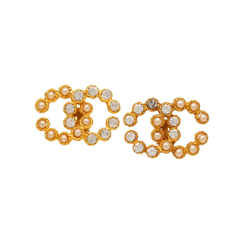 Chanel, CC Ear Clips: Chanel, CC Ear Clips CC-shaped ear clips with Gripoix imitation pearl and rhinestone settings. Standard ear clip backs. Stamped with maker's marks at back. Label: Chanel Date: 1984-1992 Country of