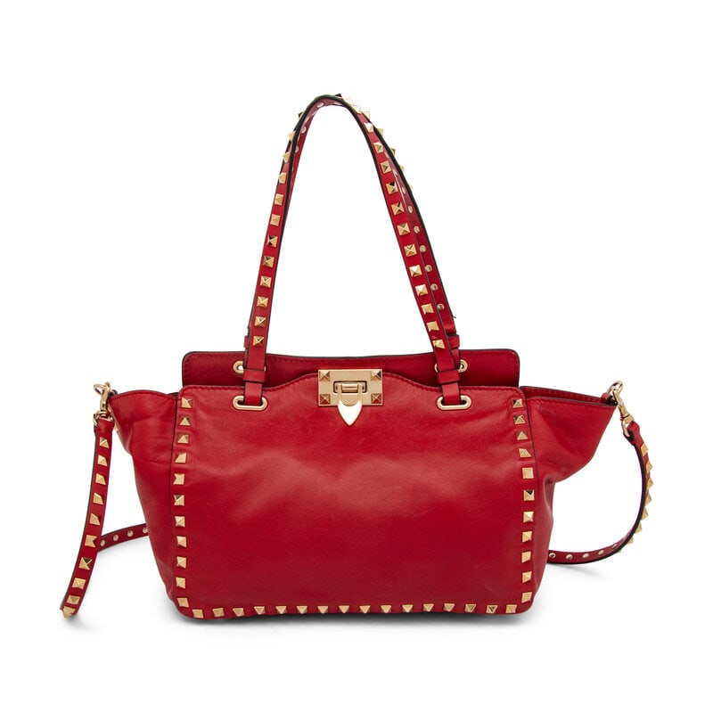 Valentino, Small Red Rockstud Tote: Valentino, Small Red Rockstud Tote Small Vitello Rockstud tote bag in crimson leather with gold-tone metal Rockstud embellishments throughout. Latch closure, Rockstud & leather handles, and