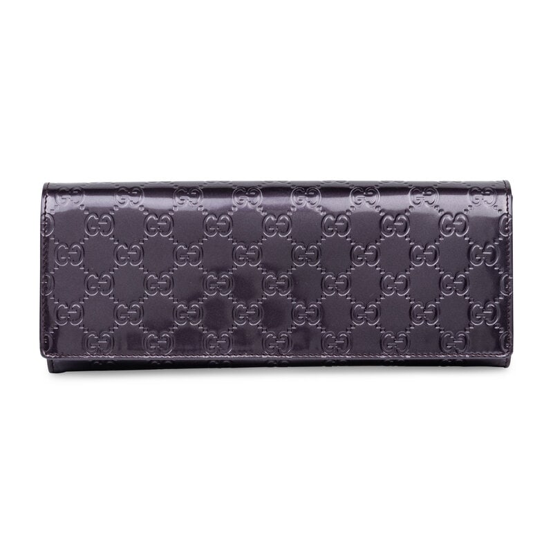 Gucci, Purple Patent Monogram Clutch: Gucci, Purple Patent Monogram Clutch Clutch in metallic purple GG monogram-embossed patent leather. Magnetic snap closure to flap. Label: Gucci Style/Serial No.: 257073 204991 Date: 2010's Country