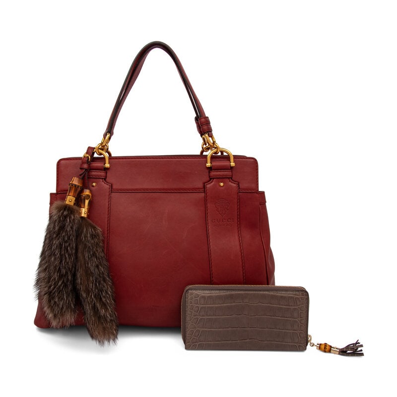 Gucci, Smilla Leather Tote Bag & Alligator Zip Wallet: Gucci, Smilla Leather Tote Bag & Alligator Zip Wallet BAG Smilla tote bag in burgundy leather with gold-tone hardware and fur & bamboo bag charms. Magnetic snap closure and flat leather