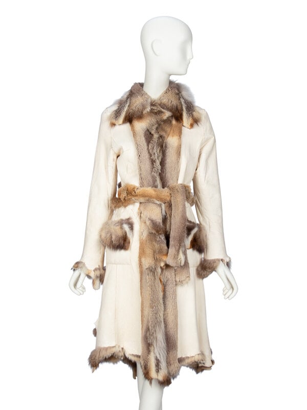 A Reversible Skin-to-Skin Fox Fur Coat: A Reversible Skin-to-Skin Fox Fur Coat Reversible skin-to-skin coat in fox fur with a cream sueded hide reverse. Knee-length. Spread collar. Full-length sleeves. Asymmetric natural raw edge