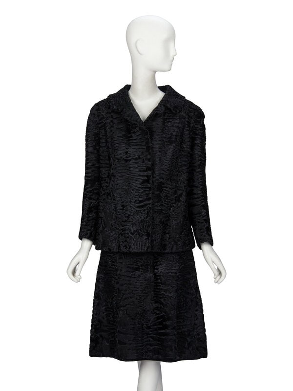 A Broadtail Skirt Suit: A Broadtail Skirt Suit Skirt suit in black broadtail fur, composed of:Jacket with spread & notched collar. Light padding at shoulders. Full-length sleeves. Hook-and-eye closures a