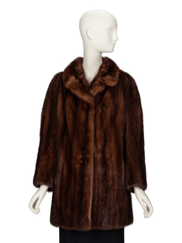 Two Fur Coats: Astrakhan and Mink: Two Fur Coats: Astrakhan and Mink THE FIRSTMid-calf length A-line coat in black Astrakhan fur. Shawl collar. Light padding at shoulders. Full-length sleeves with turned-up and stitche